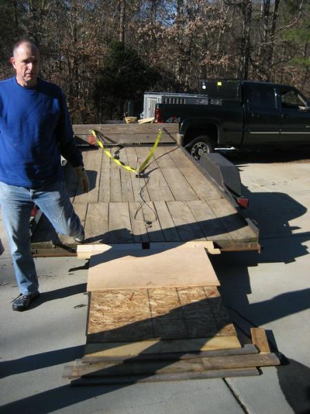 image: 3- wood placed on ramp to pull up pallet jack with press