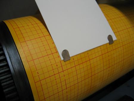 image: Tucking the Book Darts in slits in the graph paper, and tucking the printing paper in the Darts
